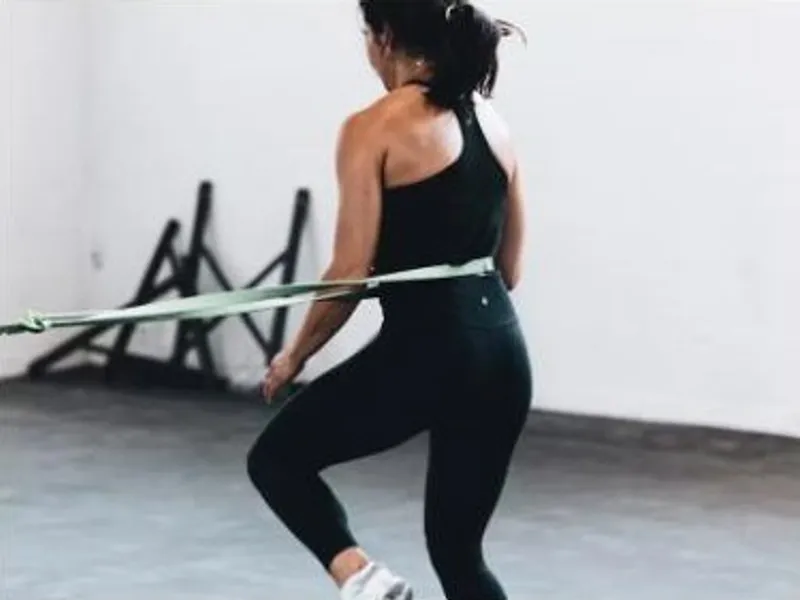 Woman doing a stability exercise with a resistance band