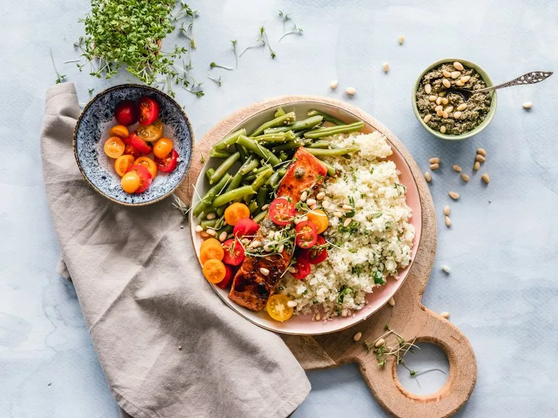 Glass meal-prep containers with rice, legumes and vegetables